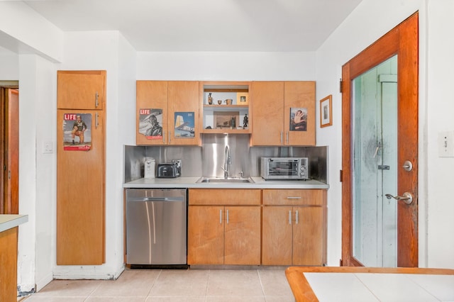 kitchen with dishwasher, light tile patterned floors, and sink