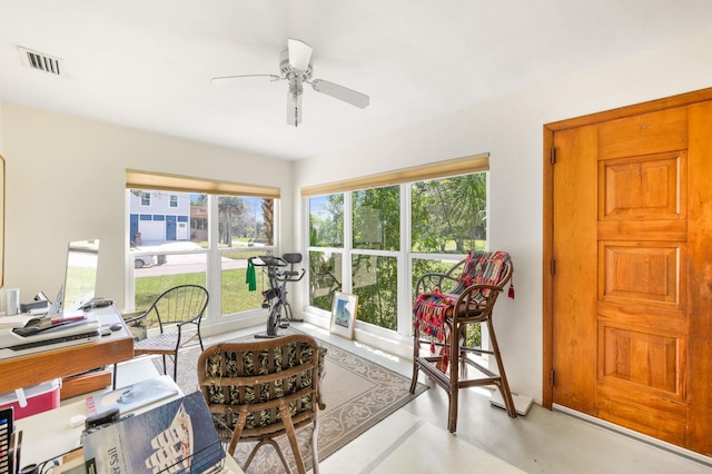 interior space with ceiling fan