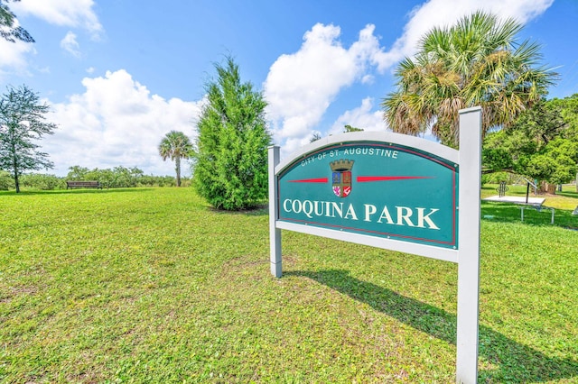 community / neighborhood sign with a lawn