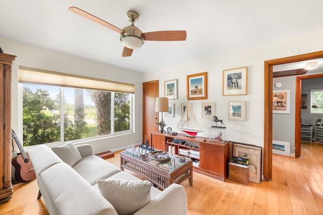 living room featuring ceiling fan and light hardwood / wood-style floors