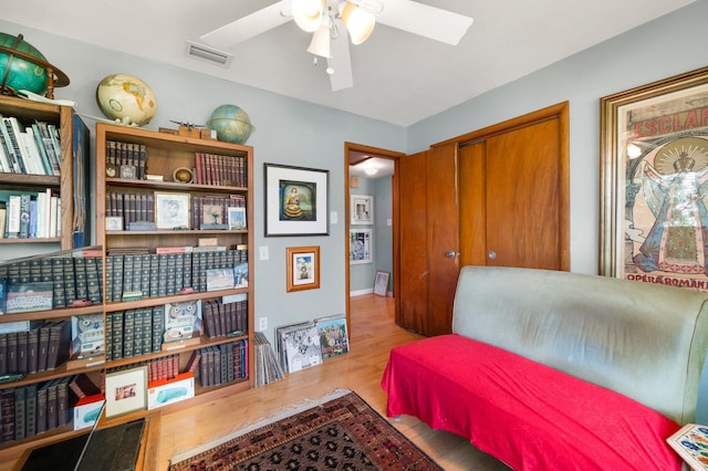 sitting room with light hardwood / wood-style floors and ceiling fan