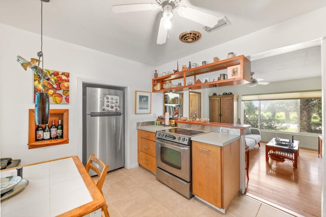 kitchen featuring hanging light fixtures, ceiling fan, light wood-type flooring, appliances with stainless steel finishes, and kitchen peninsula