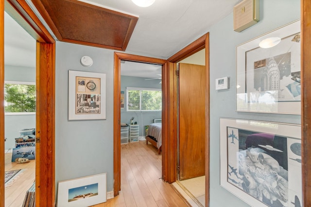 corridor with light hardwood / wood-style floors