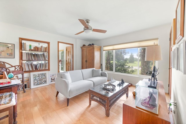 living room with light hardwood / wood-style floors and ceiling fan