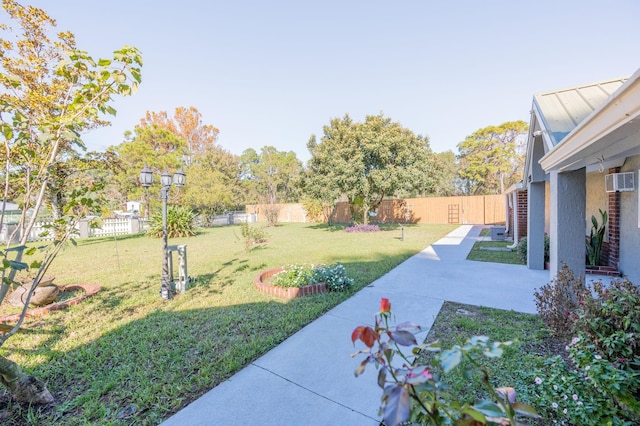 view of yard featuring a wall mounted air conditioner and a patio area