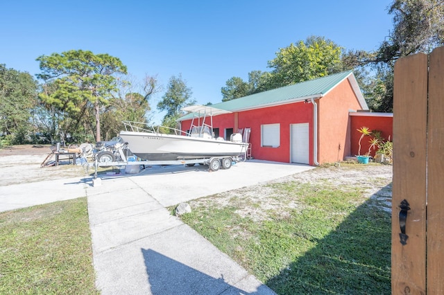 view of yard with a garage and an outbuilding