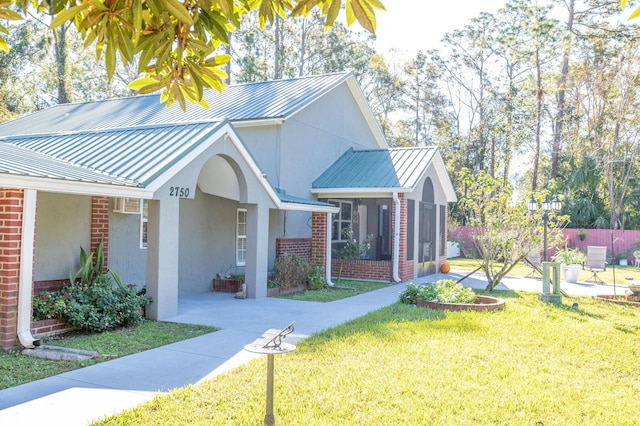 view of property exterior featuring a yard and a sunroom