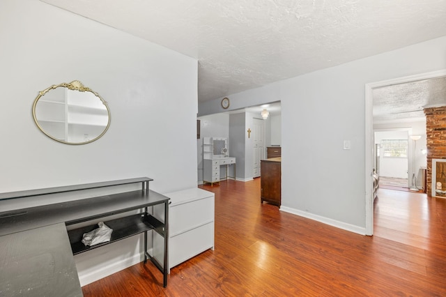 hall featuring hardwood / wood-style floors and a textured ceiling