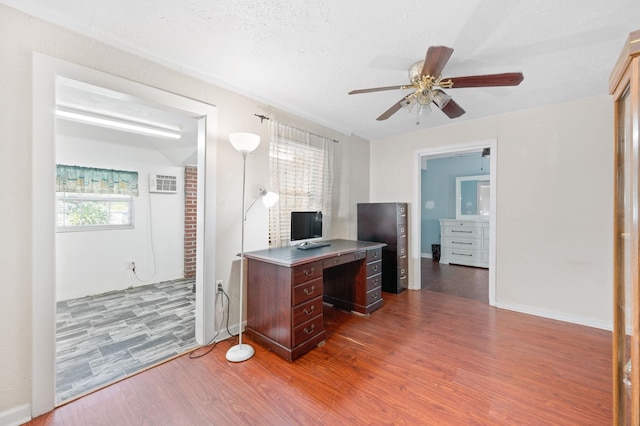 office area featuring hardwood / wood-style floors, a textured ceiling, and ceiling fan