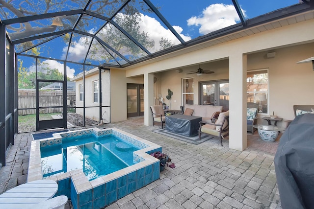 view of swimming pool featuring a lanai, a patio area, an outdoor living space, and ceiling fan