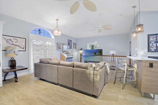 living room featuring light wood-type flooring and lofted ceiling