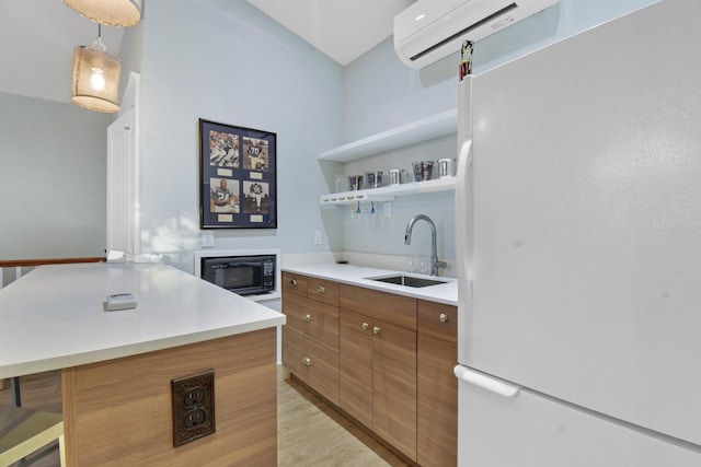 kitchen with an AC wall unit, sink, a kitchen island, white fridge, and black microwave