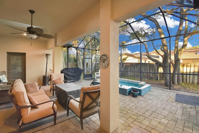 view of patio featuring an outdoor living space, grilling area, ceiling fan, a lanai, and a hot tub