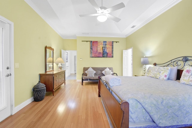 bedroom featuring hardwood / wood-style floors, ceiling fan, and crown molding