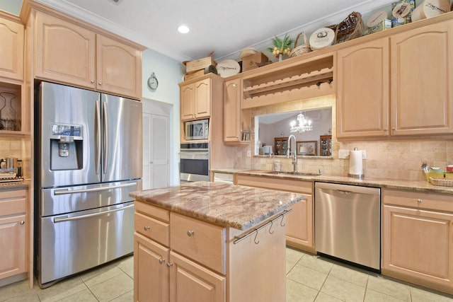 kitchen with backsplash, light tile patterned floors, sink, and appliances with stainless steel finishes