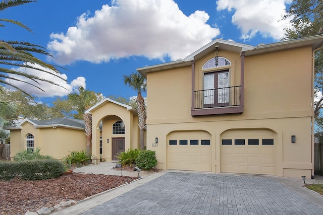 view of front of house featuring a garage and a balcony