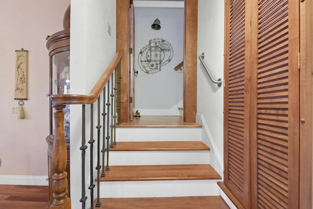 stairway featuring hardwood / wood-style flooring