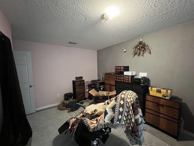 bedroom with visible vents and a textured ceiling