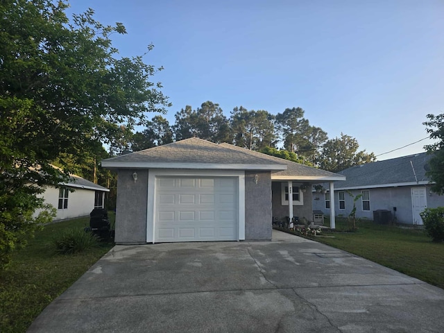 ranch-style house with a front lawn, cooling unit, and concrete driveway