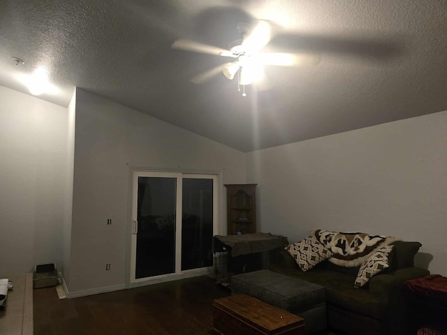 living room featuring a ceiling fan, wood finished floors, a textured ceiling, baseboards, and lofted ceiling