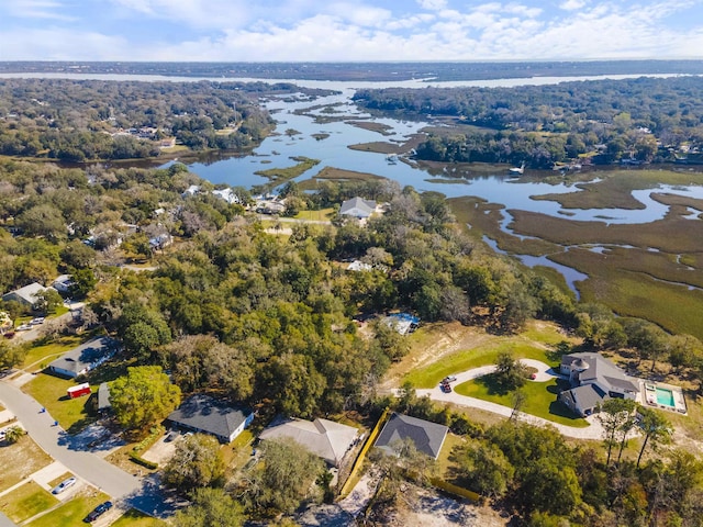 drone / aerial view with a water view and a wooded view