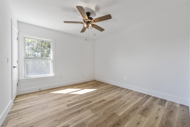 empty room featuring light wood-type flooring, ceiling fan, and baseboards