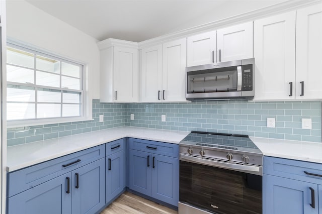 kitchen with stainless steel appliances, backsplash, and light countertops