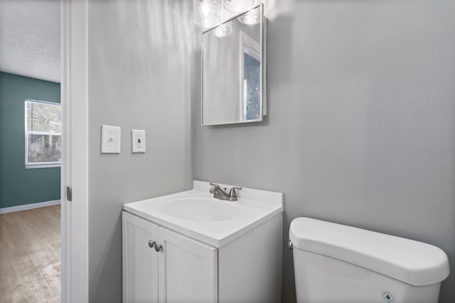 82 Andora St, Saint Augustine, FL 32086 - half bath featuring toilet, vanity, wood finished floors, and baseboards