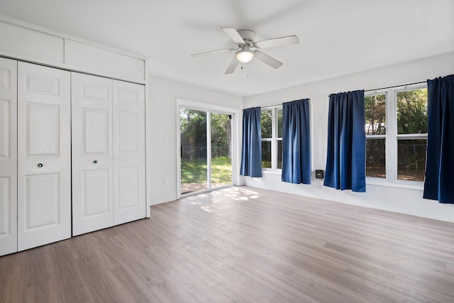 82 Andora St, Saint Augustine, FL 32086 - unfurnished bedroom with a closet, multiple windows, access to exterior, and wood finished floors