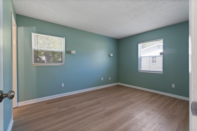 82 Andora St, Saint Augustine, FL 32086 - unfurnished room featuring a textured ceiling, wood finished floors, and baseboards
