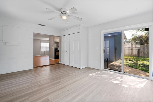82 Andora St, Saint Augustine, FL 32086 - unfurnished bedroom featuring access to outside, light wood-style flooring, a closet, a ceiling fan, and visible vents