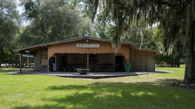 view of outbuilding featuring a yard