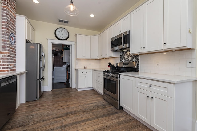 60 Saragossa St, Saint Augustine, FL 32084 - kitchen featuring visible vents, appliances with stainless steel finishes, dark wood-style flooring, light countertops, and white cabinetry