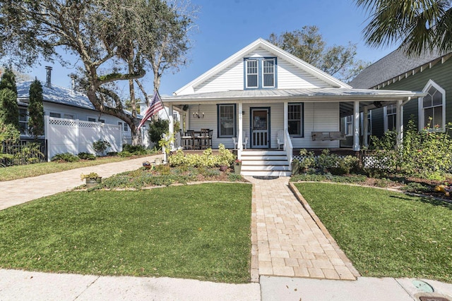 60 Saragossa St, Saint Augustine, FL 32084 - view of front of property featuring covered porch, a front lawn, and fence