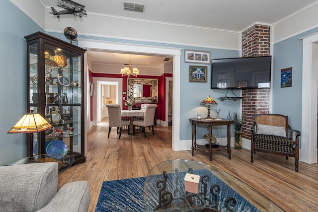 60 Saragossa St, Saint Augustine, FL 32084 - living room featuring crown molding, visible vents, an inviting chandelier, wood finished floors, and baseboards