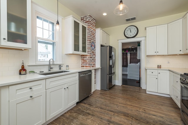60 Saragossa St, Saint Augustine, FL 32084 - kitchen with a sink, visible vents, white cabinetry, appliances with stainless steel finishes, and dark wood-style floors