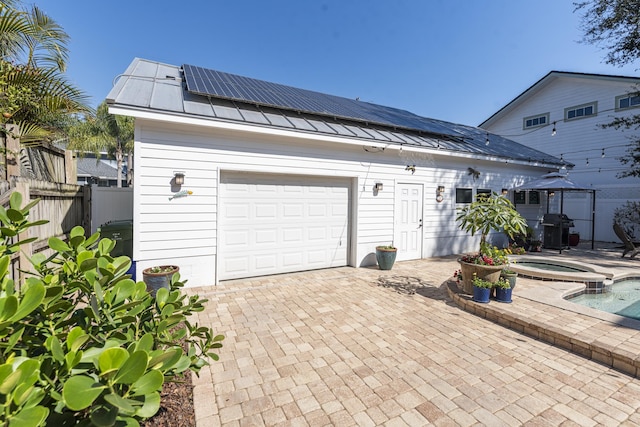 60 Saragossa St, Saint Augustine, FL 32084 - garage with solar panels, decorative driveway, and fence