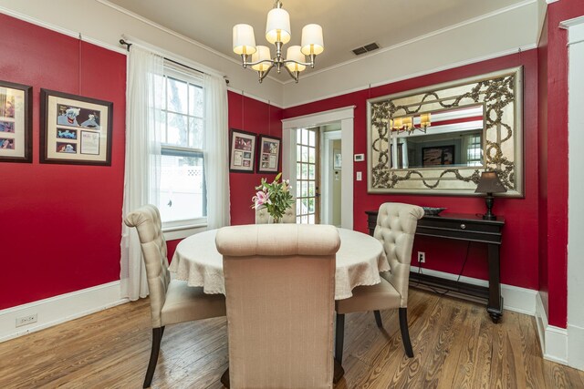 60 Saragossa St, Saint Augustine, FL 32084 - dining room featuring baseboards, visible vents, a chandelier, and wood finished floors