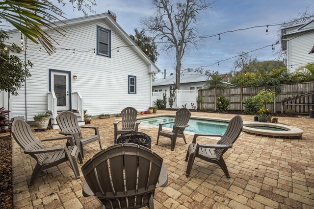 60 Saragossa St, Saint Augustine, FL 32084 - view of patio featuring a fenced in pool, fence, and an in ground hot tub