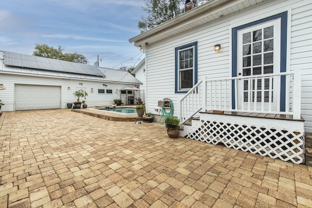 60 Saragossa St, Saint Augustine, FL 32084 - view of patio / terrace with a pool, decorative driveway, an attached garage, and a jacuzzi
