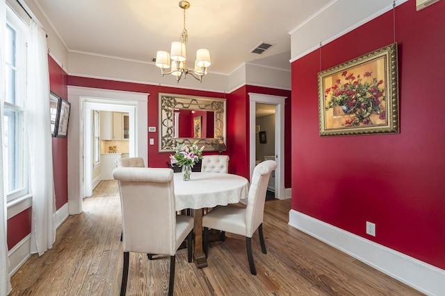60 Saragossa St, Saint Augustine, FL 32084 - dining space with ornamental molding, wood finished floors, visible vents, and baseboards