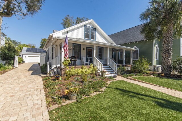 60 Saragossa St, Saint Augustine, FL 32084 - view of front facade with a garage, covered porch, and a front lawn