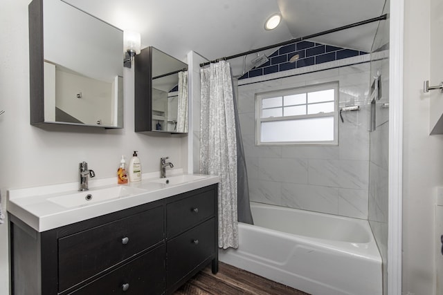 60 Saragossa St, Saint Augustine, FL 32084 - bathroom featuring wood finished floors, double vanity, a sink, and shower / bath combo with shower curtain