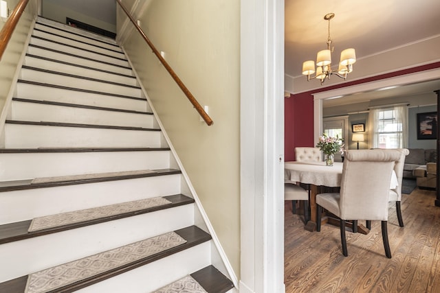 60 Saragossa St, Saint Augustine, FL 32084 - stairs with a notable chandelier, baseboards, and wood finished floors
