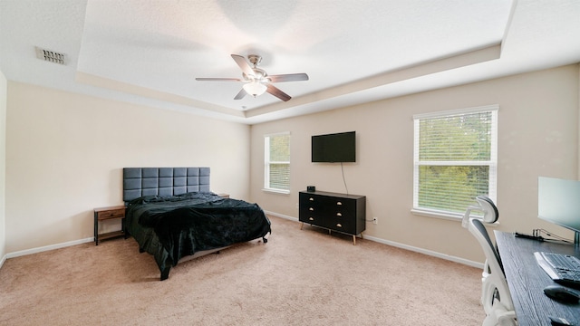 191 Timberwood Dr, Saint Augustine, FL 32084 - carpeted bedroom with baseboards, a tray ceiling, multiple windows, and visible vents