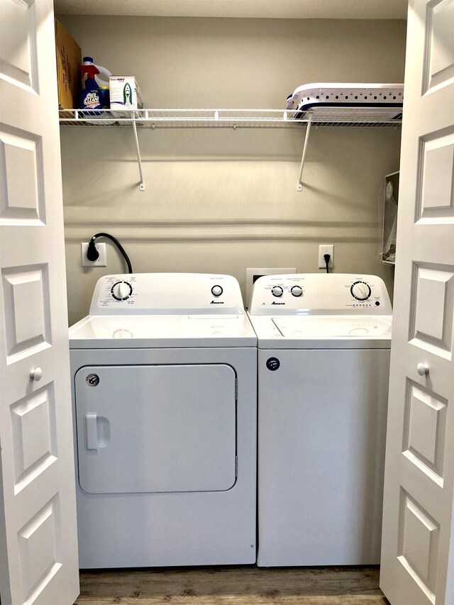 3877 Laurel St, Saint Augustine, FL 32084 - laundry room featuring washer and clothes dryer and wood finished floors