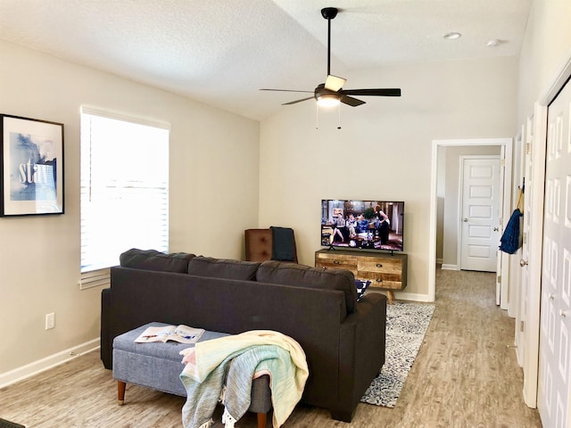 3877 Laurel St, Saint Augustine, FL 32084 - living room with light wood-type flooring, ceiling fan, baseboards, and a textured ceiling