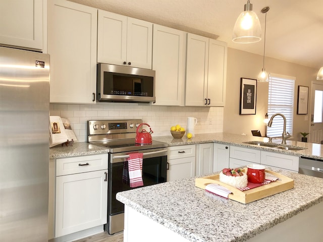 3877 Laurel St, Saint Augustine, FL 32084 - kitchen with stainless steel appliances, a sink, a kitchen island, a peninsula, and tasteful backsplash