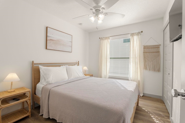 bedroom featuring ceiling fan and dark hardwood / wood-style flooring