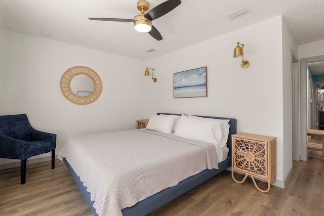 bedroom featuring wood-type flooring and ceiling fan